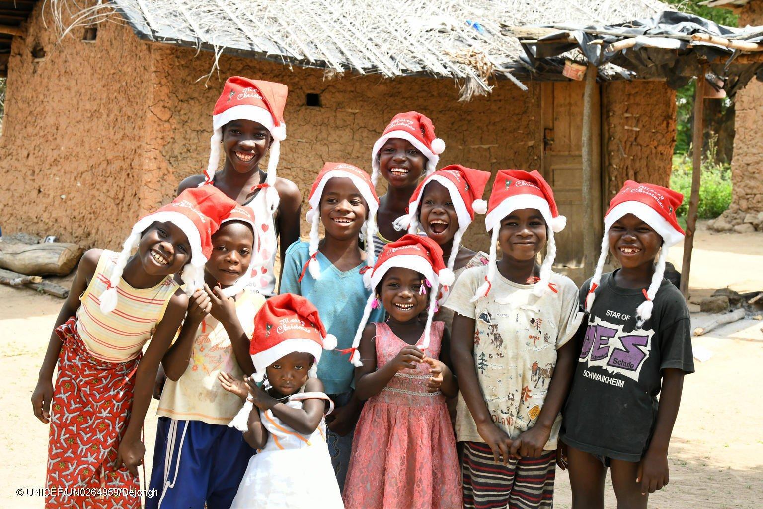Children posing with Christmas hats in Sakassou, Côte d'Ivoire