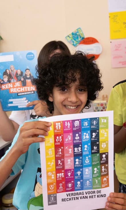 Jongen met kinderrechtenposter.