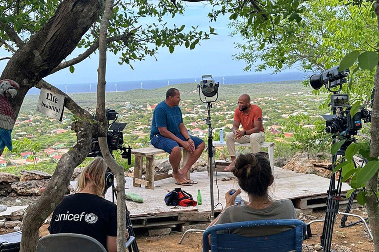 Archell in gesprek met een vader op Bonaire voor de opnames van 'Raising our Future'.