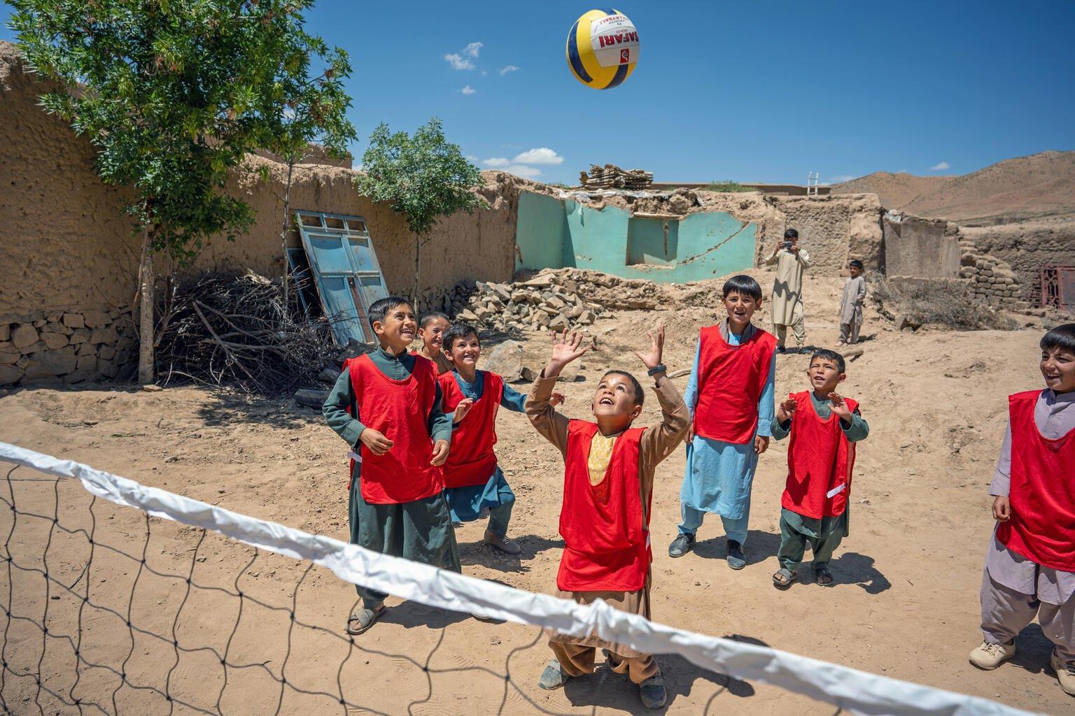 kinderen spelen met bal bij net